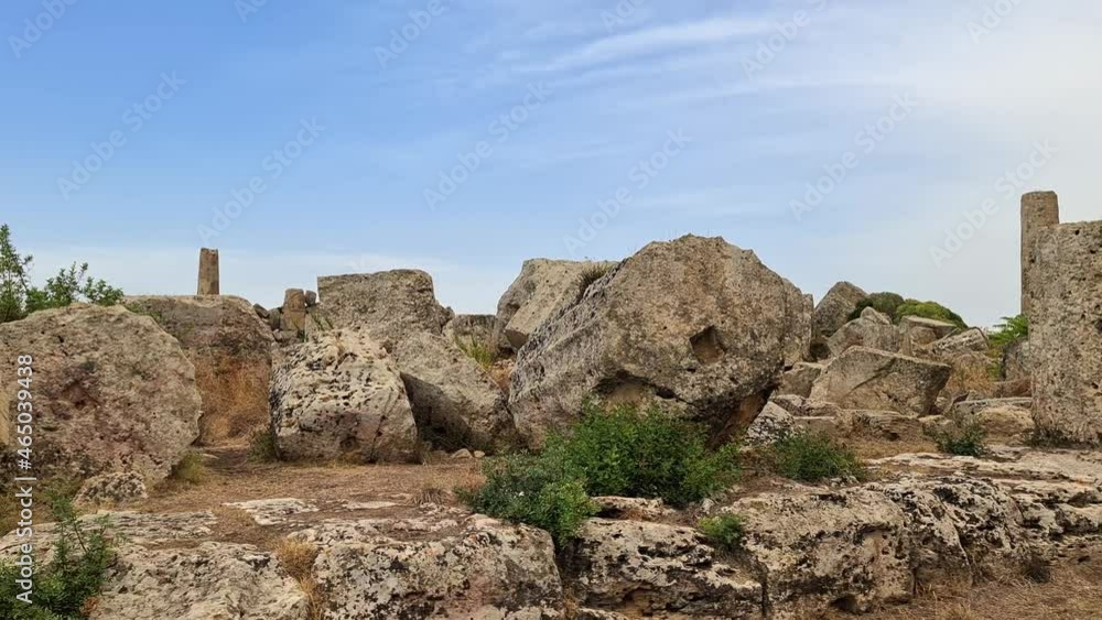 Ruins of collapsed Greek temples and columns at Selinunte archaeological park in Sicily, Italy. Paning Ruins of collapsed Greek temples and columns at Selinunte archaeological park in Sicily, Italy. Paning