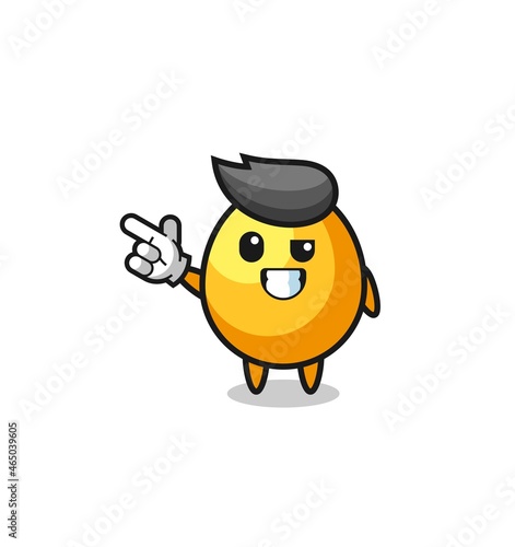 golden egg mascot pointing top left © heriyusuf