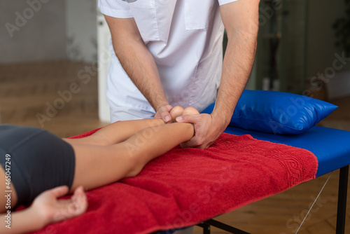 Wellness massage for children. Hands of the masseur close-up. Physiotherapist working with patient in clinic