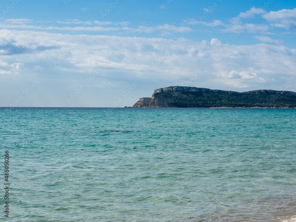 turquoise water in the mediterranean sea in sardinia with mountains