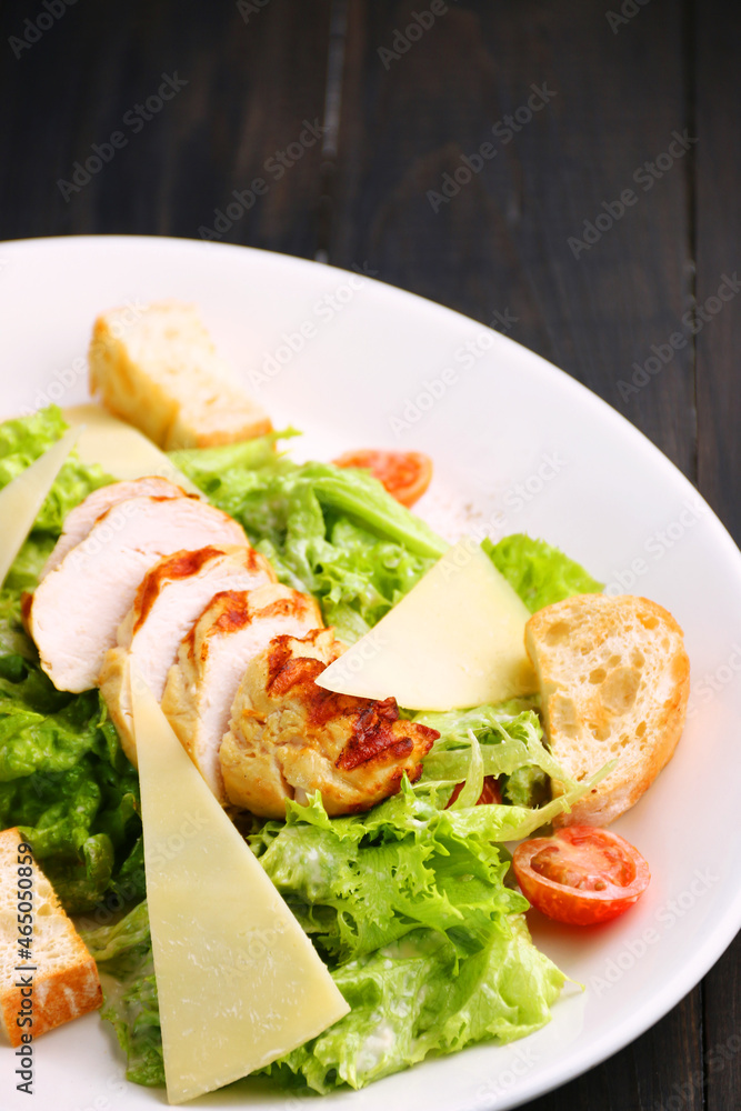 Caesar salad close up. chicken caesar salad with parmesan cheese Caesar salad close up. chicken caesar salad with parmesan cheese