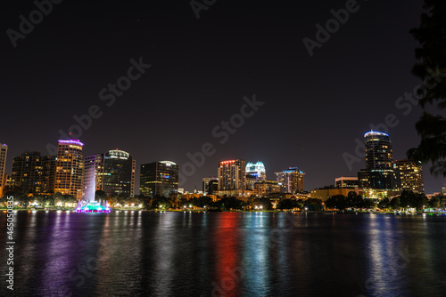 night skyline of downtown orlando with a lake in foreground