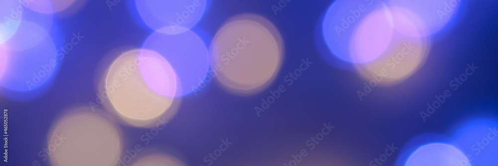 Banner made with the blurred lights of the garlands are blue and yellow. Light Blue bokeh background. Festive background. New Year's background. Banner made with the blurred lights of the garlands are blue and yellow. Light Blue bokeh background. Festive background. New Year's background.