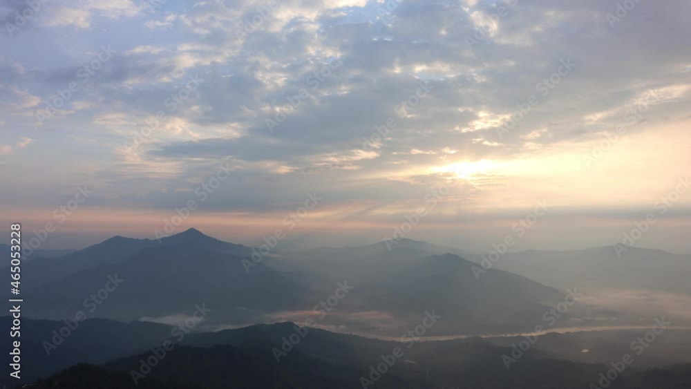 The view at sunrise from the horizon on top of a mountain with a river and a sea of mist in the background. Pha Tang Viewpoint, Wiang Kaen District, Chiang Rai Province, Thailand The view at sunrise from the horizon on top of a mountain with a river and a sea of mist in the background. Pha Tang Viewpoint, Wiang Kaen District, Chiang Rai Province, Thailand