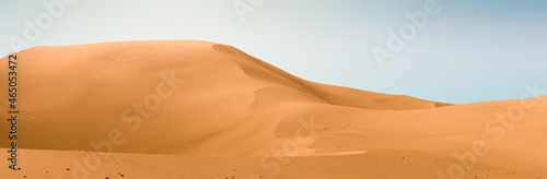 Yellow dunes and bright blue sky. Desert dunes landscape with contrast skies. Minimal abstract background. 3d rendering