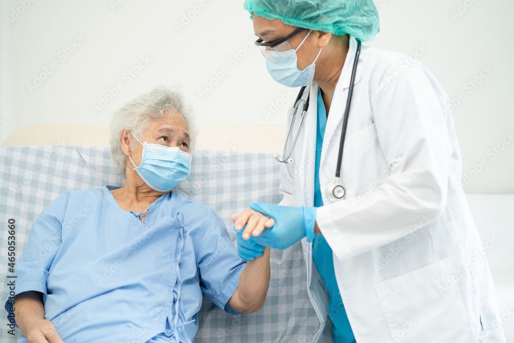 Doctor help Asian senior or elderly old lady woman patient wearing a face mask in hospital for protect safety infection and kill Covid-19 Coronavirus. Doctor help Asian senior or elderly old lady woman patient wearing a face mask in hospital for protect safety infection and kill Covid-19 Coronavirus.