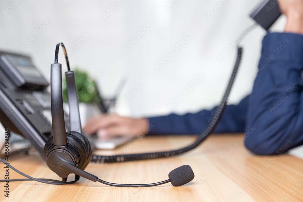 Call center staff man hand point to press the button number on the phone office desk , Communication support, call center and customer service help desk. for (call center) concept Call center staff man hand point to press the button number on the phone office desk , Communication support, call center and customer service help desk. for (call center) concept