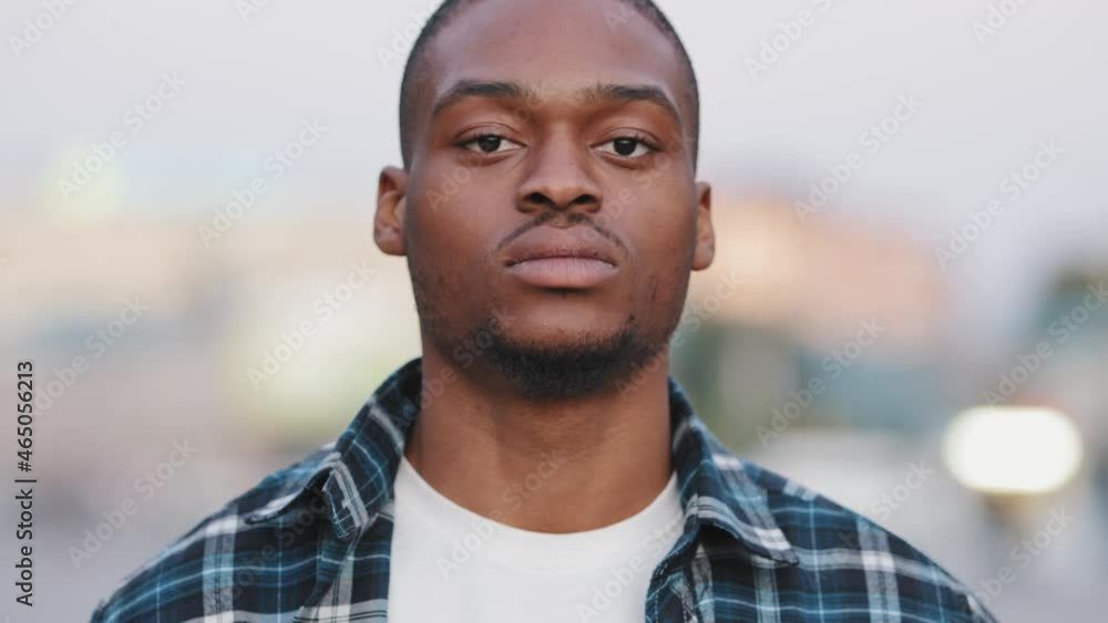 Portrait outdoors serious angry male face african american man looking at camera standing in urban city handsome confident guy looks street lifestyle Real people close up facial confidence human gaze Portrait outdoors serious angry male face african american man looking at camera standing in urban city handsome confident guy looks street lifestyle Real people close up facial confidence human gaze