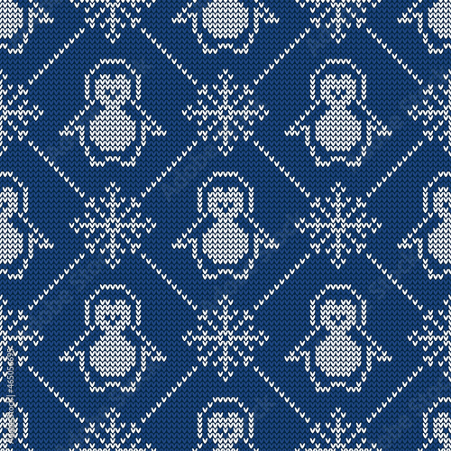 Knitted seamless pattern with penguins and snowflakes. Sweater background.