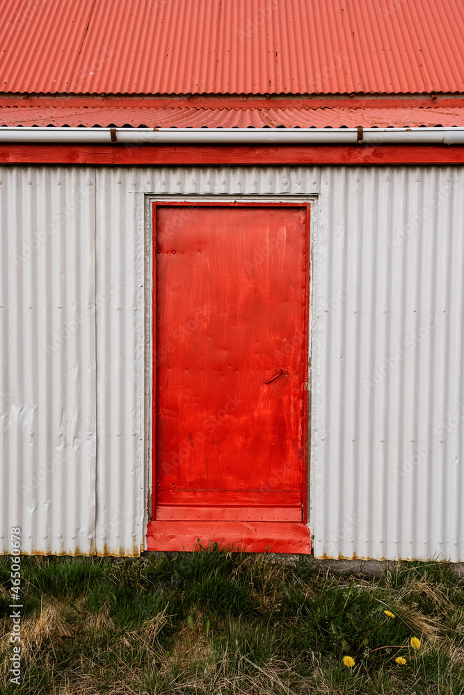 Red door of building with red walls Red door of building with red walls