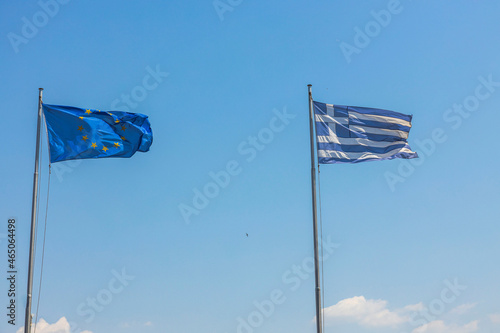 Beautiful view of Greece and Europe flags on blue sky background. Greece. 