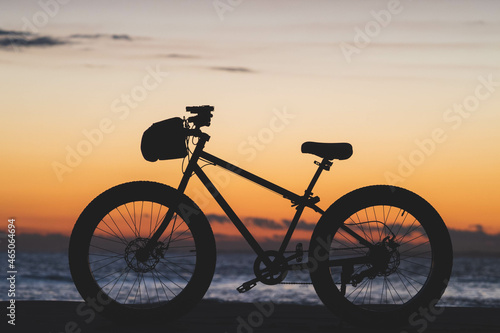 silhouette of a bike on the beach