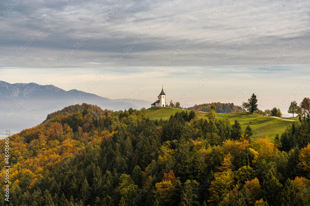 view of the Church of Saint Primoz and the Julian Alps in late autumn
