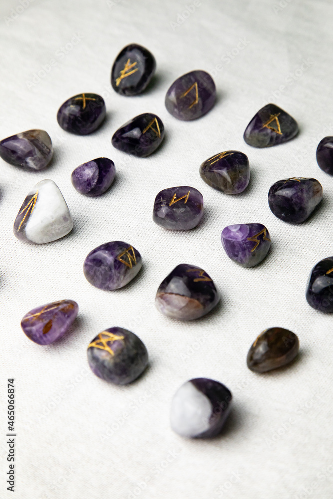 Viking ancient rune stones carved on gemstones.
Rune stone on a wooden table. Viking ancient rune stones carved on gemstones.
Rune stone on a wooden table.