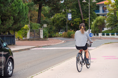 woman riding a bicycle in the city of Hossegor © Image'in