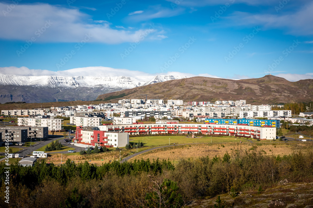 Obraz premium Reykjavik, Iceland - October 1, 2021: Panorama of Reykjavik suburbs. Ulfarsfell hill and snowy Mount Esja in background.