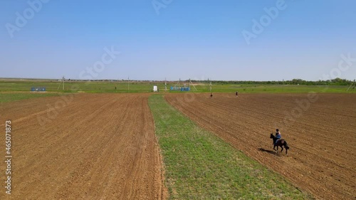 Horse racing competition, people sitting on top. Aerial view from above.