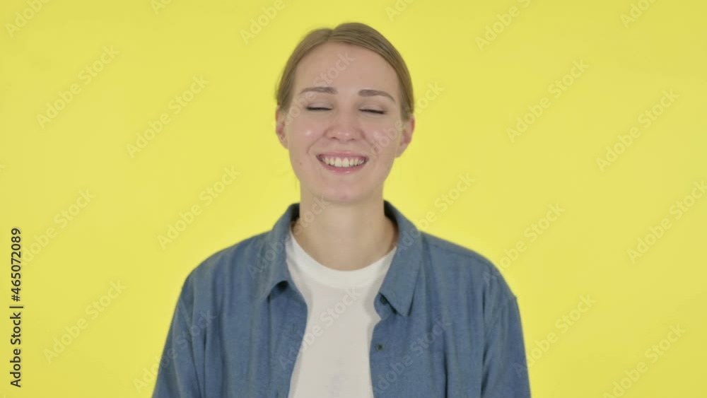Young Woman Pointing at Camera, Inviting on Yellow Background Young Woman Pointing at Camera, Inviting on Yellow Background