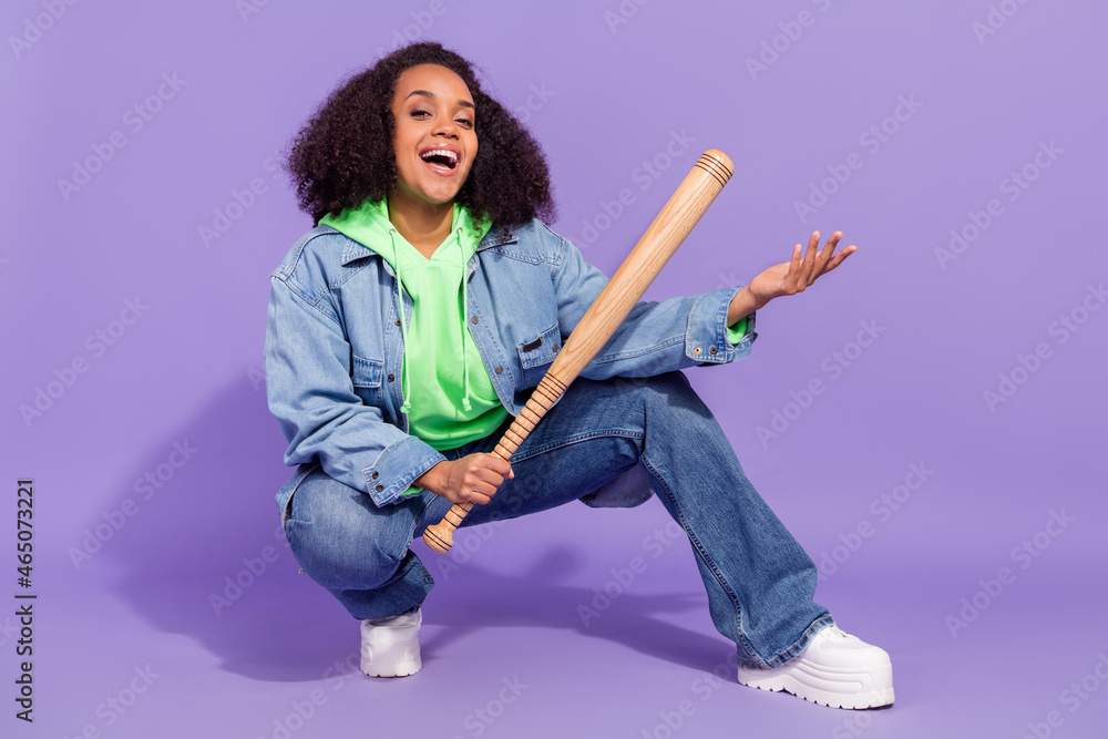 Full length portrait of brutal hooligan girl hold bat toothy smile look camera isolated on violet color background Full length portrait of brutal hooligan girl hold bat toothy smile look camera isolated on violet color background