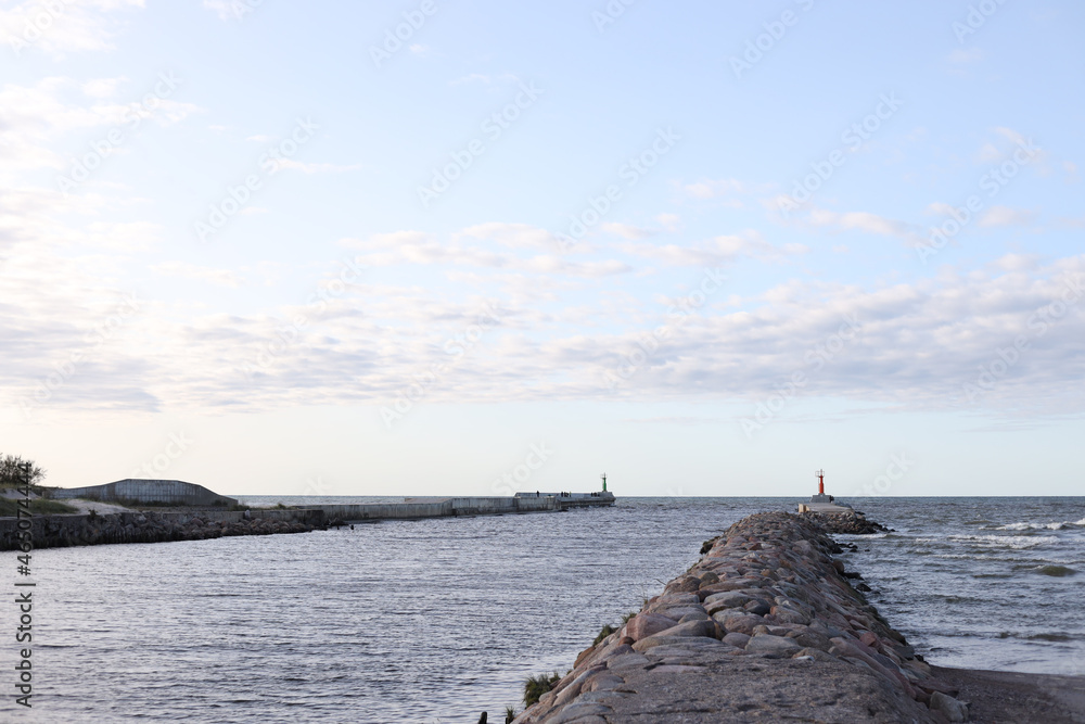 Old ship pier from rocks with view to Baltic sea.