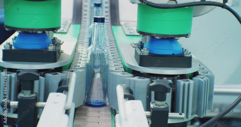 empty glass bottles move along the conveyor of the filling line.close-up. empty glass bottles move along the conveyor of the filling line.close-up.