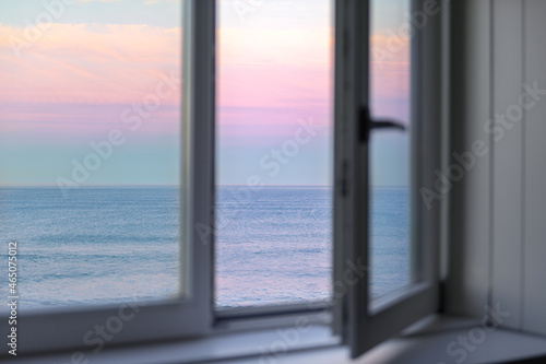 Sunrise over Atlantic Ocean through the open window © manuta