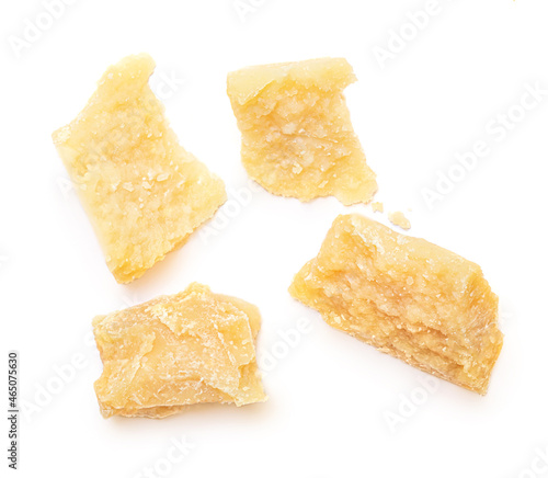 Pieces of parmesan cheese isolated on white background. Pattern. Parmesan top view. Flat lay.