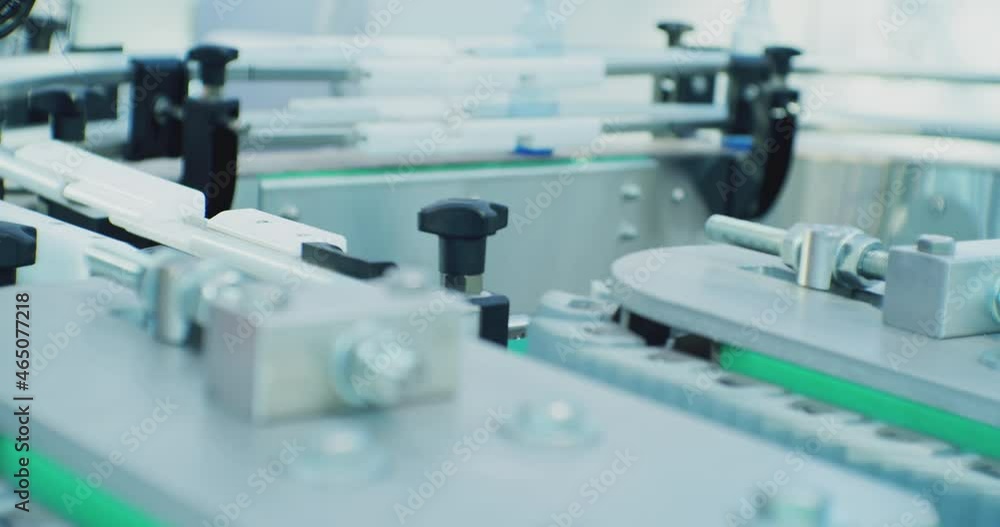 modern industrial production.glass bottles move along the conveyor of the filling line.close-up shooting of the technological process. modern industrial production.glass bottles move along the conveyor of the filling line.close-up shooting of the technological process.
