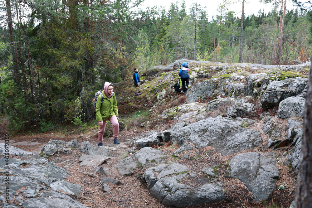 Mother with two sons climbing Mount Hiidenvuori