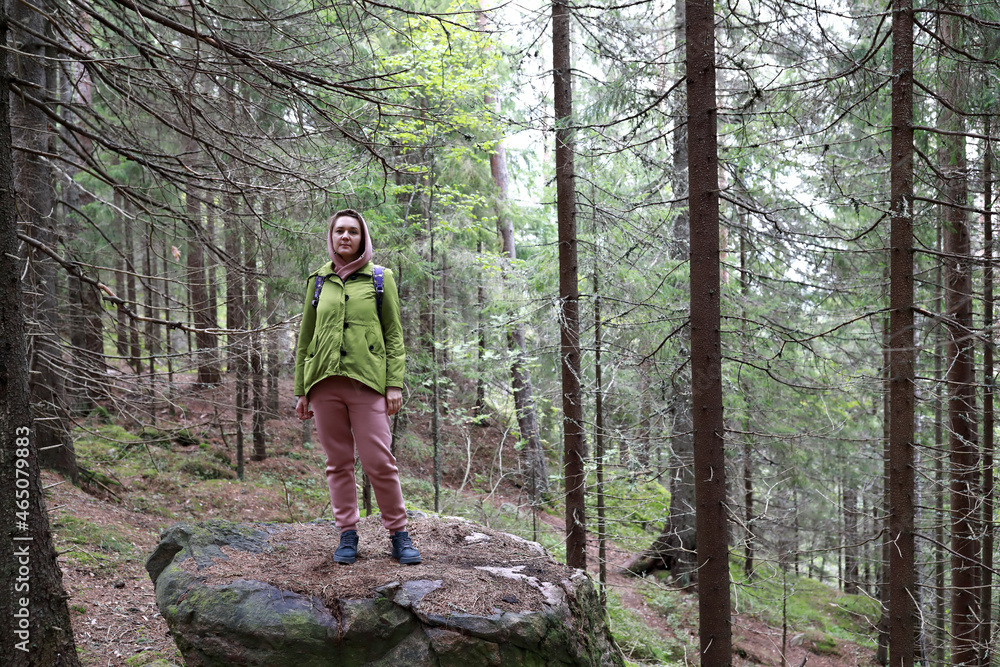 Fototapeta premium Woman at foot of Mount Hiidenvuori