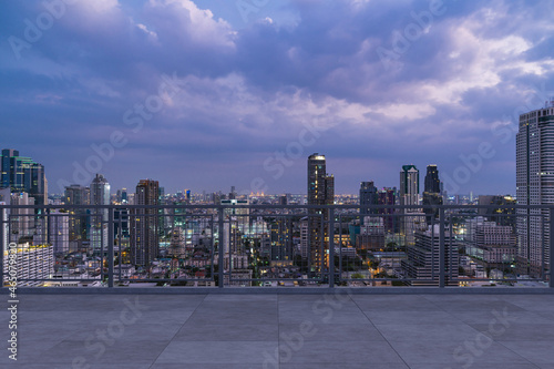 Panoramic Bangkok skyline view, concrete observatory deck on rooftop, night time. Asian corporate and residential lifestyle. Financial city downtown, real estate. Product display mockup empty roof