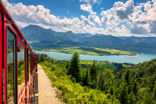 Schafbergbahn mountain train, Schafberg mountain, Salzkammergut region, Salzburg Land state, Austria. Journey to the top of Alps through lush fields and green forests.View of lake Wolfgangsee. photo