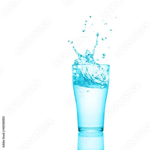 Glass of fresh water with splash and reflection isolated on white background.
