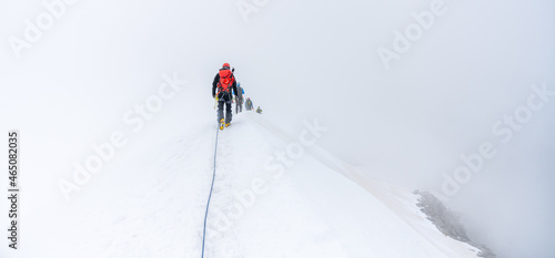 Fotografie Group of glacier mountaineers on a rope