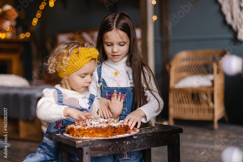 Children eat delicious cake with their hands. Homemade baking. Thanksgiving holiday life moments. Lifestyle siblings sisters