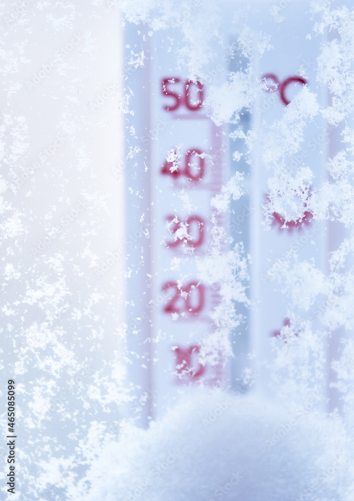 Thermometer in the winter on snow-covered window. Winter background.