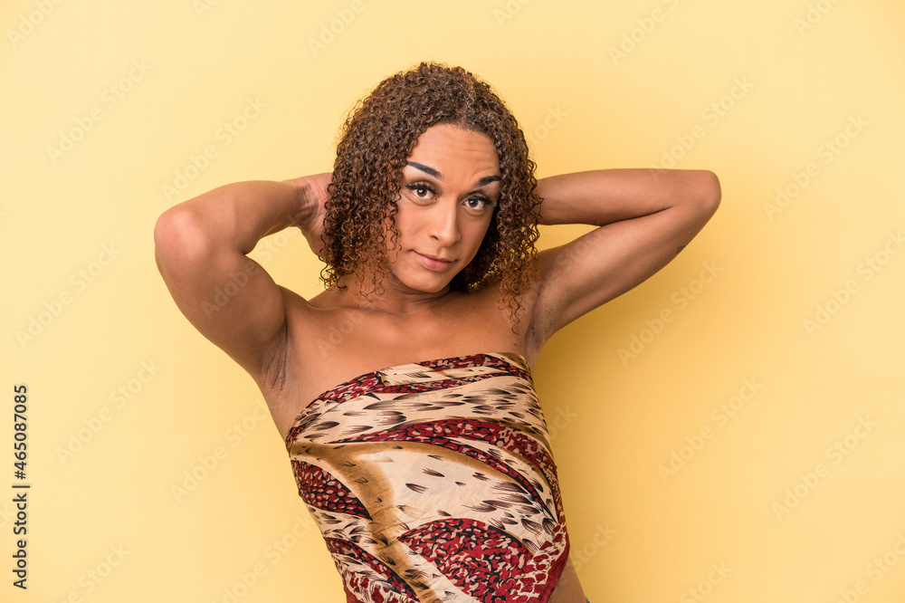 Young latin transsexual woman isolated on yellow background feeling confident, with hands behind the head. Young latin transsexual woman isolated on yellow background feeling confident, with hands behind the head.