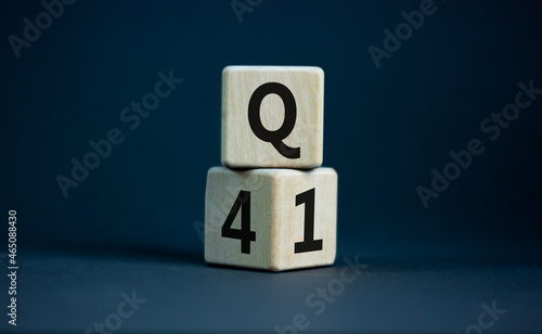 From 4th to 1st quarter symbol. Turned wooden cubes and changed words 'Q4' to 'Q1'. Beautiful grey table, grey background. Business, happy 1st quarter Q1 concept, copy space.