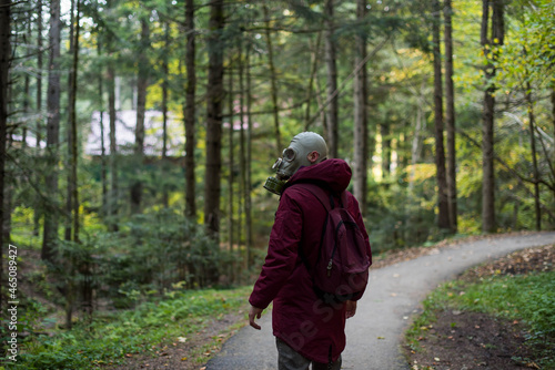 Wallpaper Mural casual young man in a gas mask standing on the forest. Ecological catastrophy. Post apocalyptic survivor in gas mask. Man at forest. Torontodigital.ca