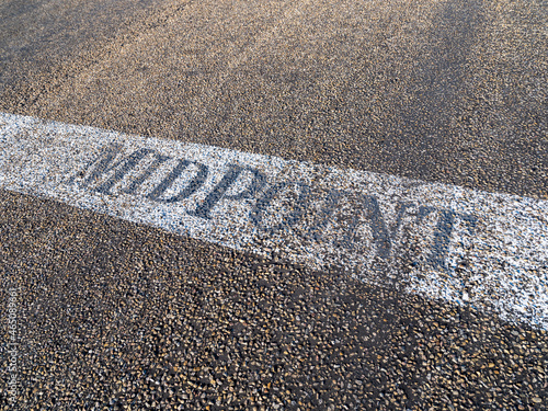 Midpoint sign painted on the Route 66 pavement at the halfway point between Chicago and Los Angeles in Adrian Texas.