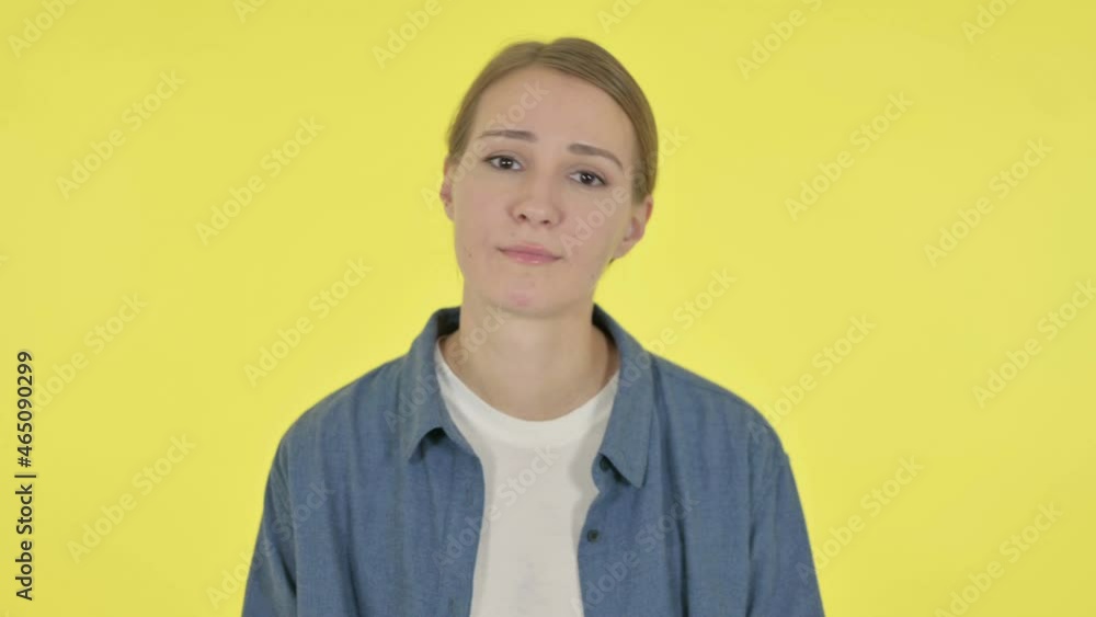 Disappointed Young Woman Reacting Loss on Yellow Background Disappointed Young Woman Reacting Loss on Yellow Background