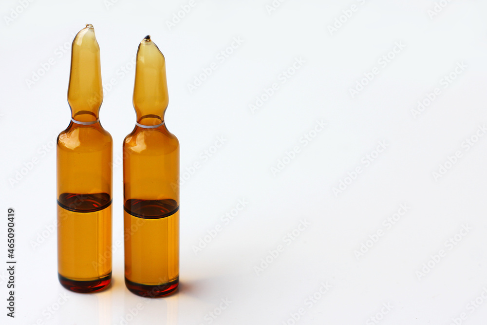 Glass ampoules with medicine or chemical reagent on the table. Medical ampoules close-up. Beauty salon concept. Glass ampoules with medicine or chemical reagent on the table. Medical ampoules close-up. Beauty salon concept.