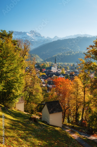 City Garmisch-Partenkirchen in autumn with beautiful fall colors, clear blue sky and snow white mountains