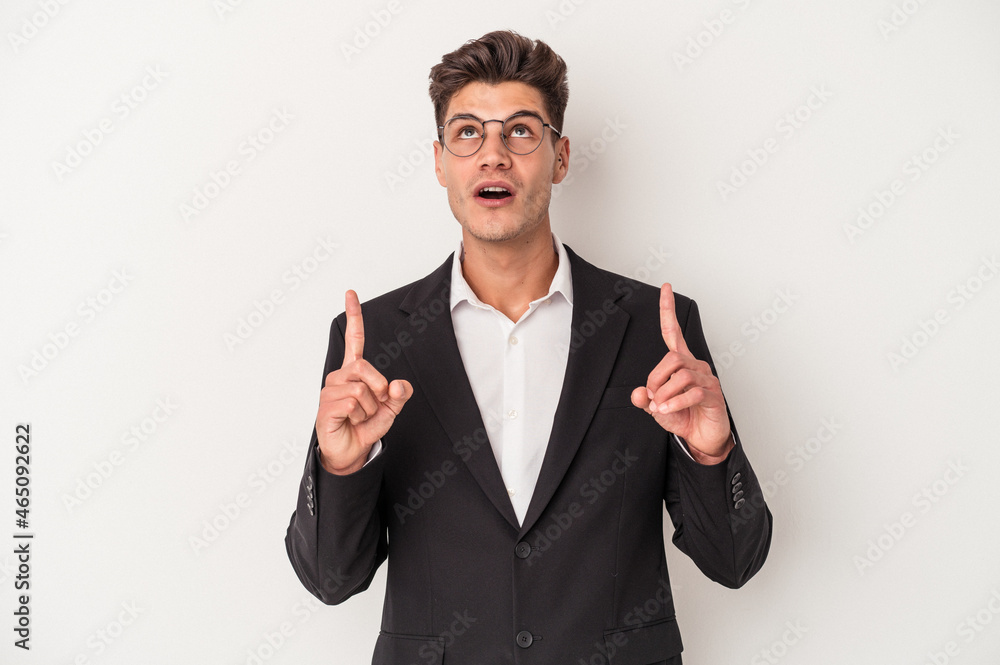 Young business caucasian man isolated on white background pointing upside with opened mouth. Young business caucasian man isolated on white background pointing upside with opened mouth.