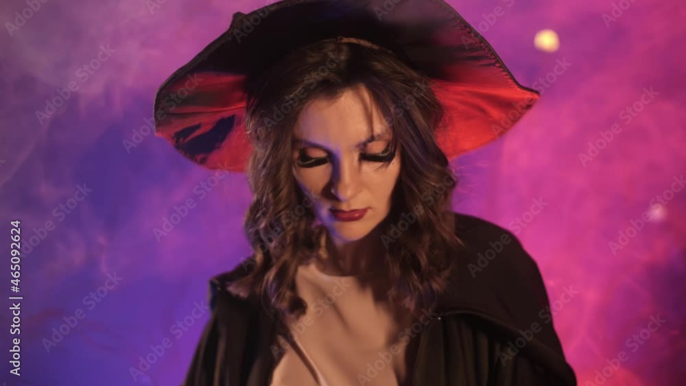 beautiful witch cuts a pumpkin for halloween beautiful witch cuts a pumpkin for halloween