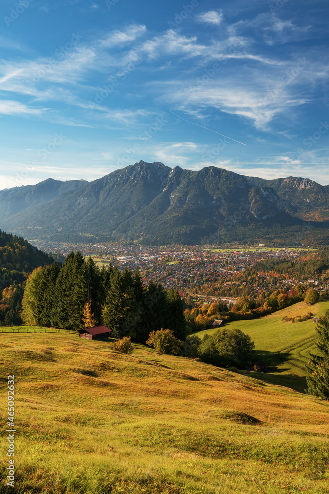 View of the valley with city Garmisch-Partenkirchen in autumn with fall colors. Changing season with beautiful fall weather