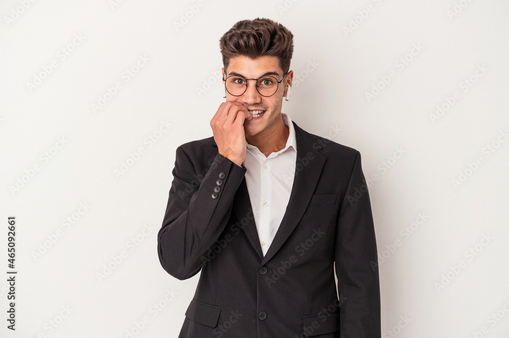 Young business caucasian man wearing headphones isolated on white background biting fingernails, nervous and very anxious. Young business caucasian man wearing headphones isolated on white background biting fingernails, nervous and very anxious.
