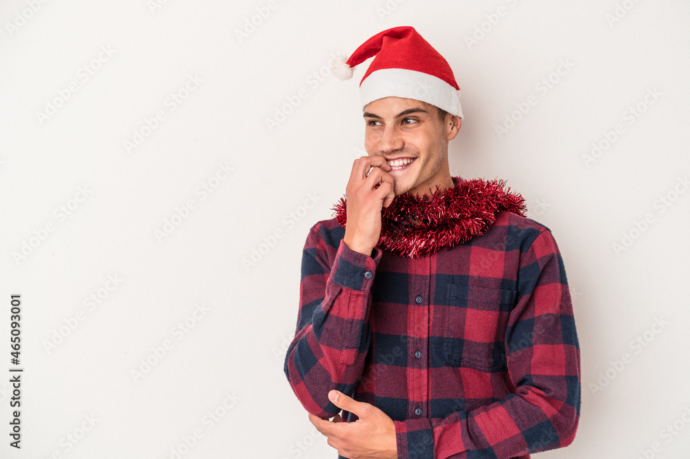 Young caucasian man celebrating Christmas isolated on white background relaxed thinking about something looking at a copy space. Young caucasian man celebrating Christmas isolated on white background relaxed thinking about something looking at a copy space.