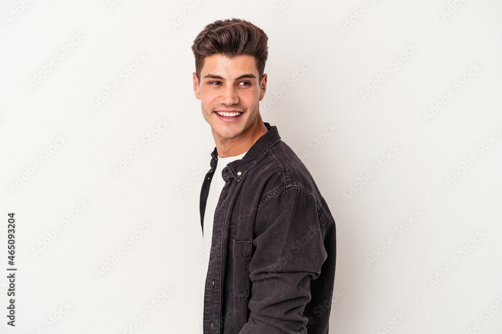 Young caucasian man isolated on white background looks aside smiling, cheerful and pleasant. Young caucasian man isolated on white background looks aside smiling, cheerful and pleasant.