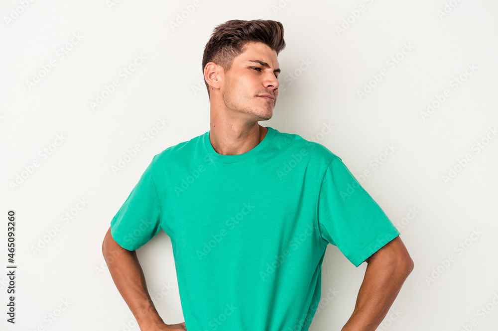 Fototapeta premium Young caucasian man isolated on white background dreaming of achieving goals and purposes